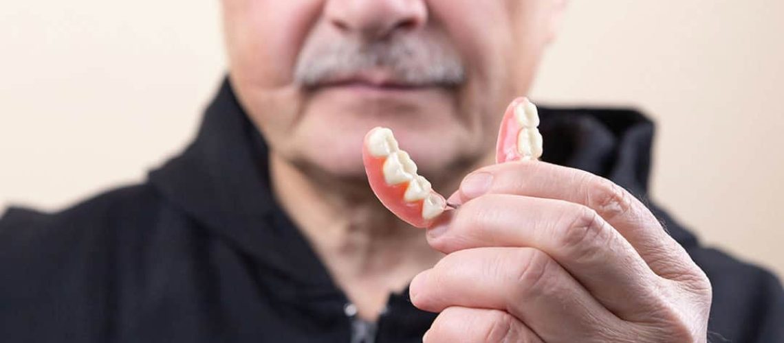 elderly man with loose denture